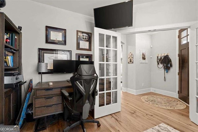 office featuring french doors and light wood-type flooring