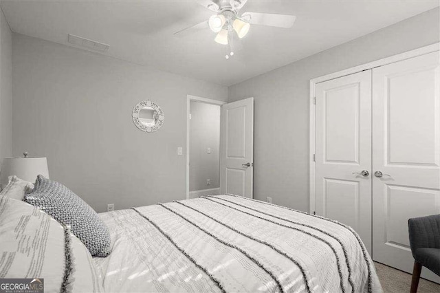 carpeted bedroom featuring a closet and ceiling fan