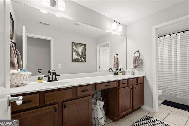 bathroom featuring vanity, toilet, curtained shower, and tile patterned flooring