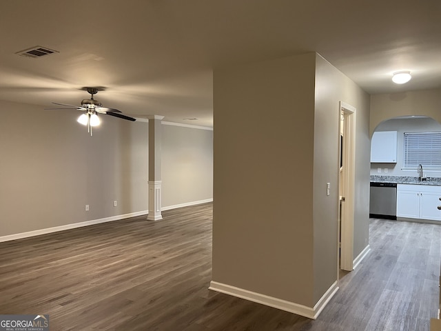 interior space featuring crown molding, sink, and dark hardwood / wood-style floors