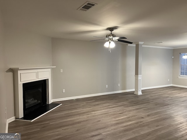 unfurnished living room featuring ceiling fan, dark hardwood / wood-style floors, and crown molding