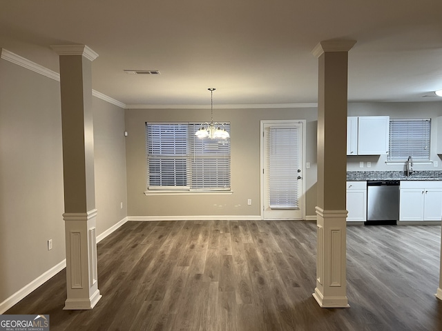 unfurnished dining area with sink, decorative columns, dark hardwood / wood-style floors, and ornamental molding