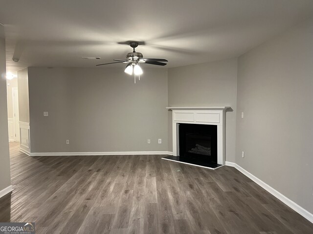 unfurnished living room with ceiling fan and hardwood / wood-style flooring