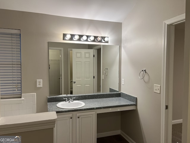 bathroom featuring vanity and backsplash