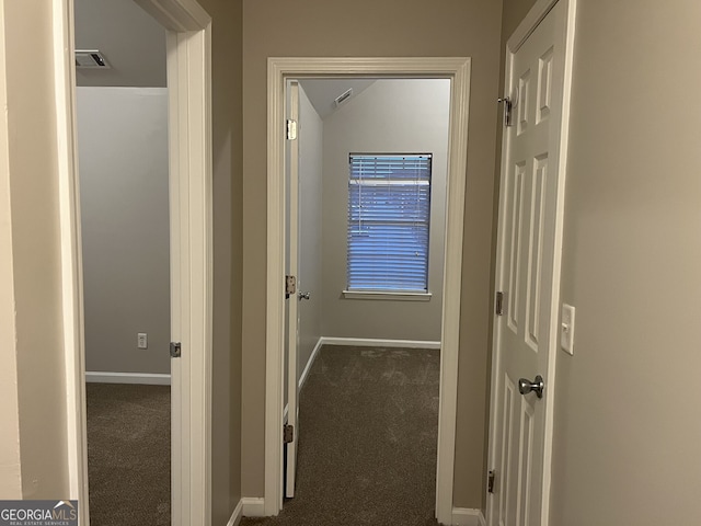 corridor with vaulted ceiling and carpet