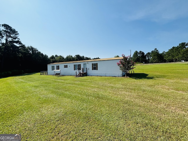 back of property with a lawn