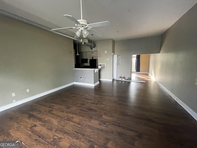 unfurnished living room with dark hardwood / wood-style floors and ceiling fan