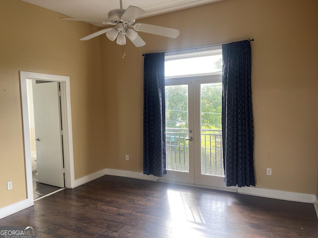 unfurnished room with dark wood-type flooring, ceiling fan, and french doors