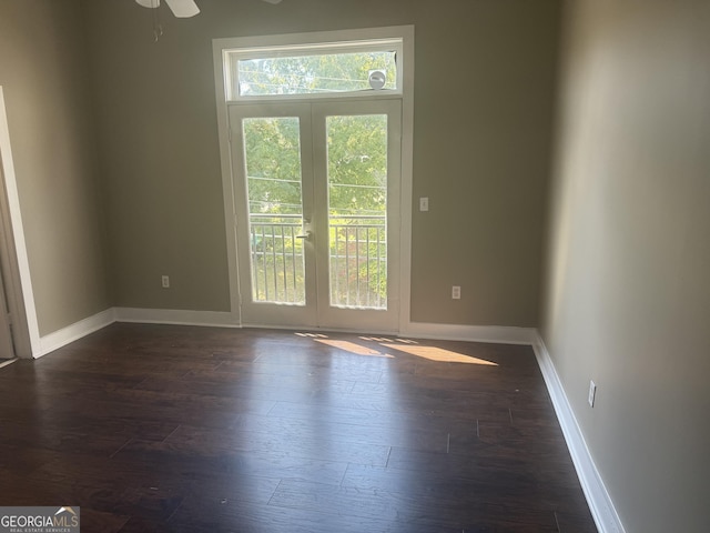 empty room with dark wood-type flooring and french doors