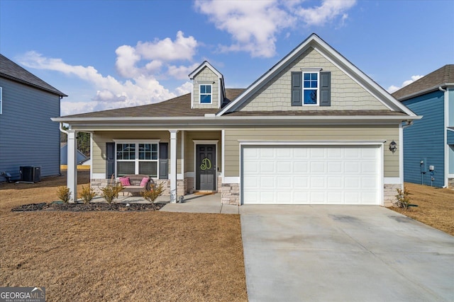 craftsman-style home featuring a garage, central AC, and a porch