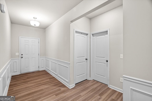 hallway with light hardwood / wood-style flooring