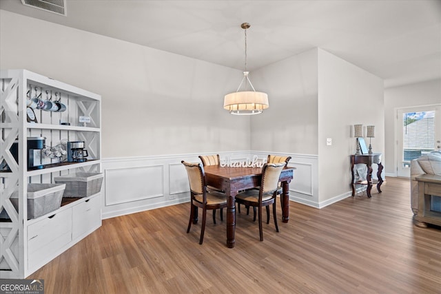 dining room with light hardwood / wood-style floors and built in features