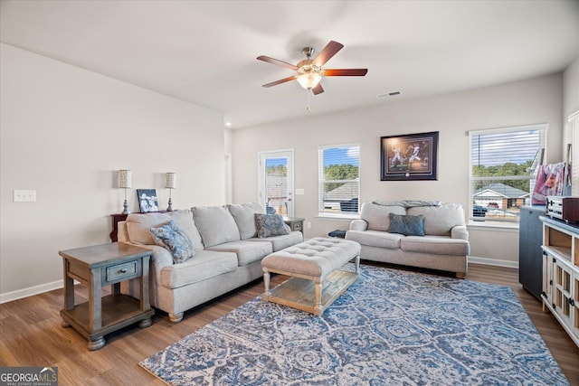 living room with ceiling fan, a healthy amount of sunlight, and hardwood / wood-style floors