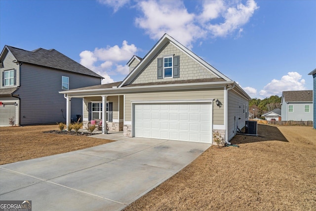 craftsman-style house with a garage, cooling unit, and covered porch