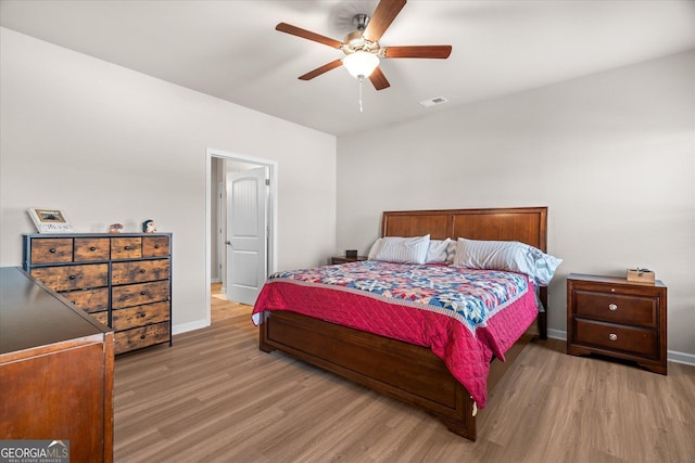 bedroom with ceiling fan and light wood-type flooring