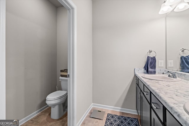 bathroom featuring vanity, toilet, and tile patterned flooring