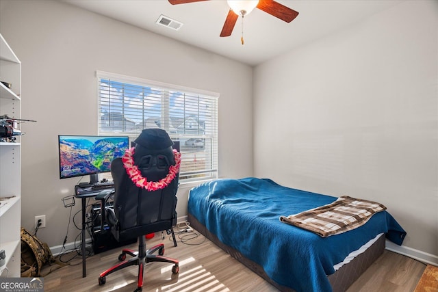 bedroom with hardwood / wood-style floors and ceiling fan