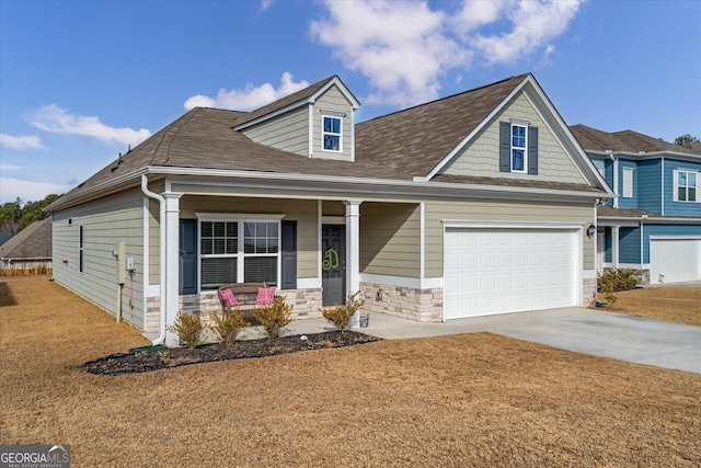 view of front of house with a garage, a front lawn, and covered porch