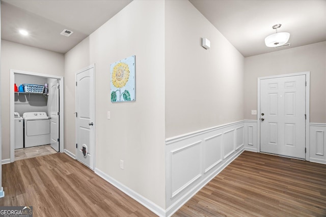 hallway featuring washing machine and clothes dryer and hardwood / wood-style floors