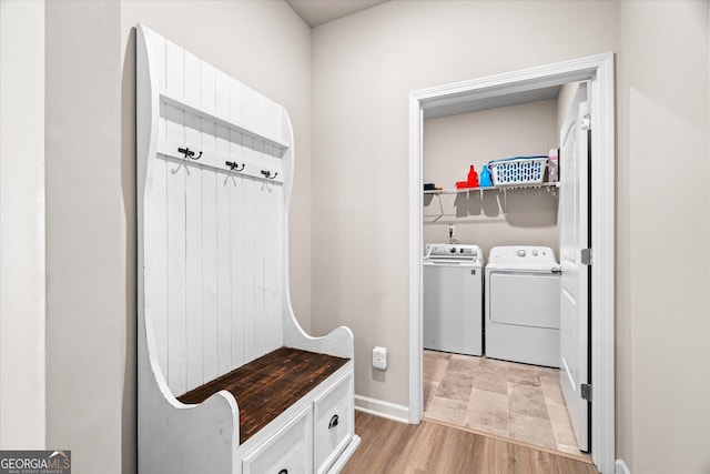 mudroom with washer and clothes dryer and light hardwood / wood-style floors