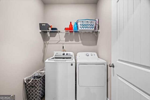 clothes washing area featuring separate washer and dryer