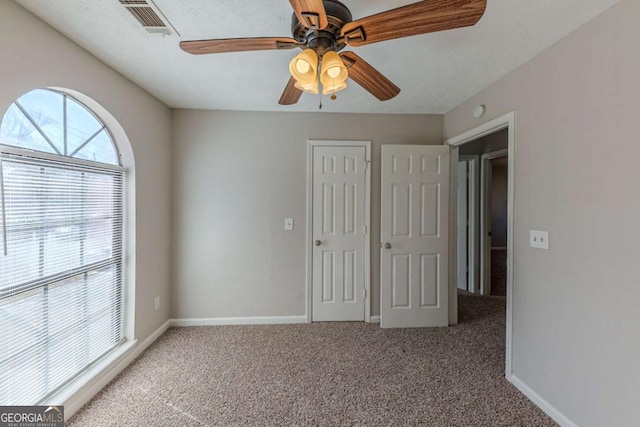 unfurnished bedroom with carpet flooring and ceiling fan