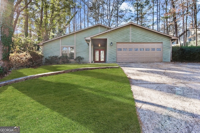 single story home featuring a garage and a front yard