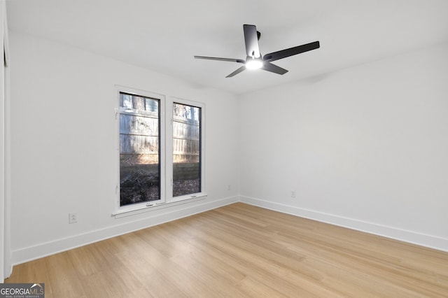 empty room with ceiling fan and light hardwood / wood-style floors