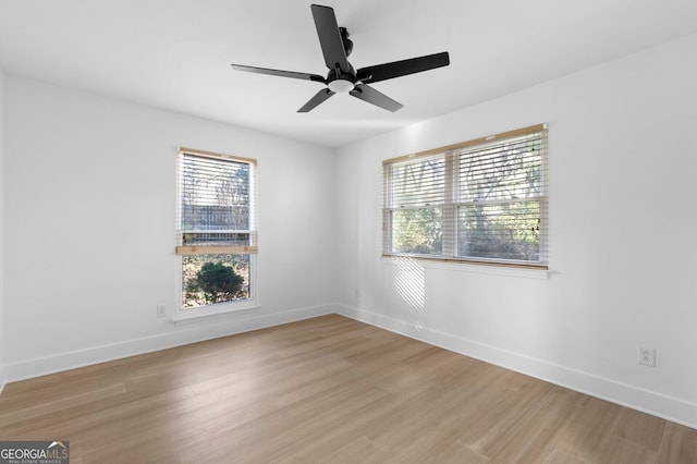 spare room with light wood-type flooring and ceiling fan