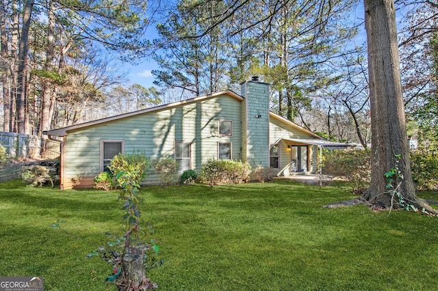 view of side of property with a yard