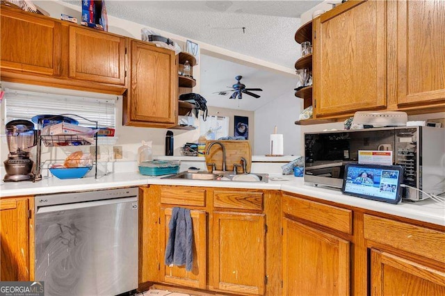 kitchen featuring sink, ceiling fan, a textured ceiling, and stainless steel dishwasher