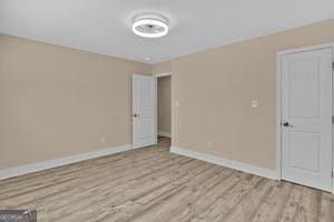 unfurnished room with light wood-type flooring