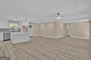 unfurnished living room with light wood-type flooring and ceiling fan