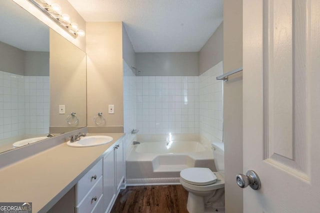 bathroom with wood-type flooring, toilet, and vanity