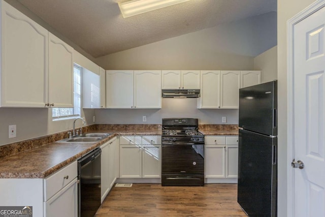 kitchen with black appliances, a textured ceiling, white cabinetry, sink, and vaulted ceiling