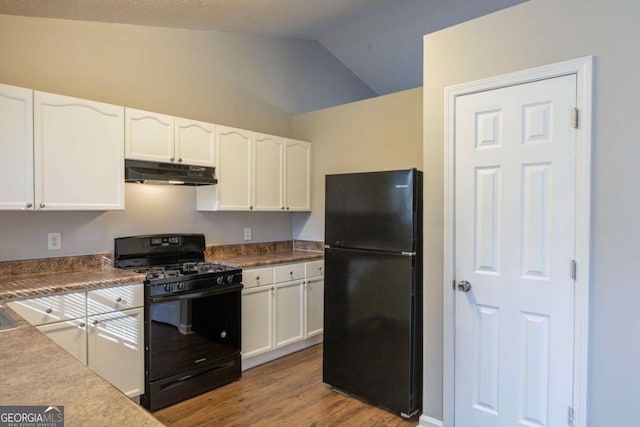 kitchen featuring black appliances, hardwood / wood-style floors, a textured ceiling, white cabinetry, and vaulted ceiling