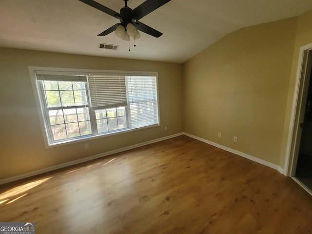 empty room featuring ceiling fan, hardwood / wood-style floors, and lofted ceiling