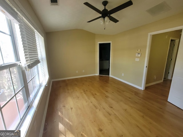 empty room with ceiling fan, light hardwood / wood-style floors, and lofted ceiling