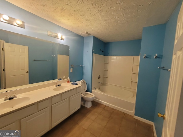 full bathroom with a textured ceiling, tile patterned flooring, bathing tub / shower combination, vanity, and toilet