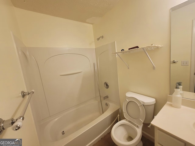 full bathroom with shower / washtub combination, toilet, a textured ceiling, and vanity