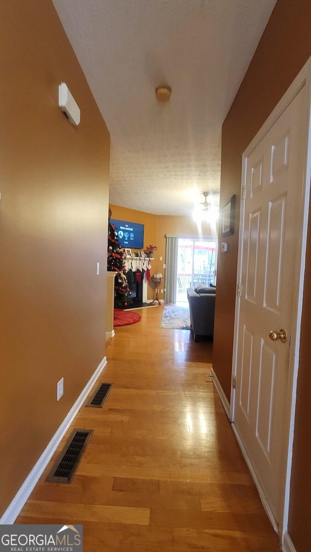 hallway featuring wood-type flooring