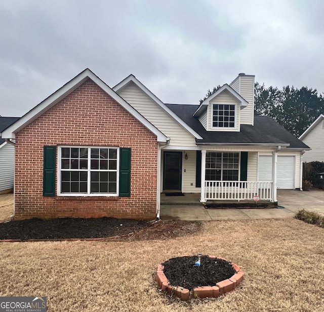 view of front facade with a garage, a front yard, and a porch