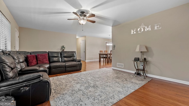 living room featuring hardwood / wood-style flooring and ceiling fan