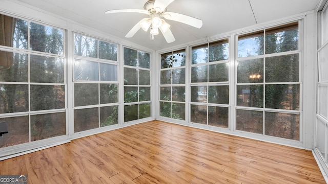 unfurnished sunroom featuring ceiling fan