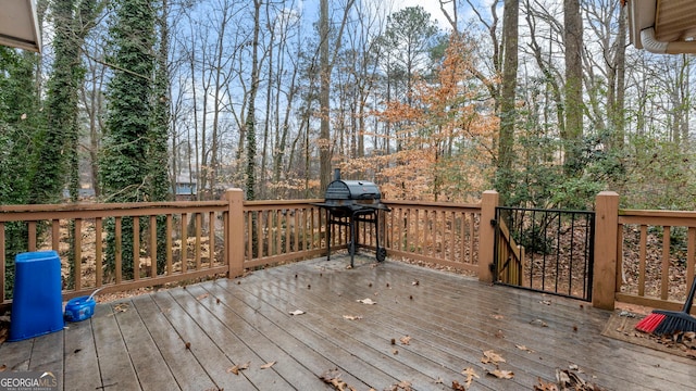 wooden deck with a grill