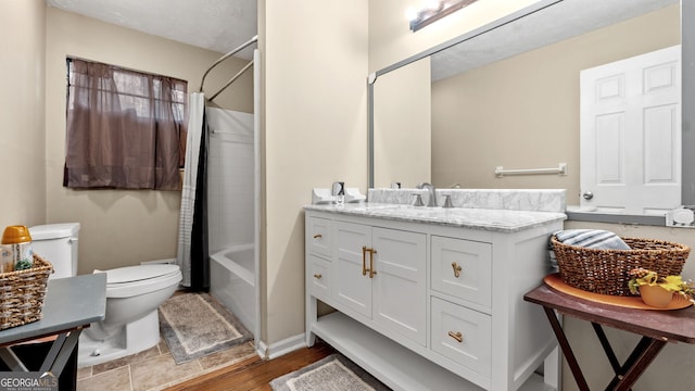 full bathroom featuring vanity, wood-type flooring, shower / bath combination with curtain, a textured ceiling, and toilet