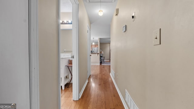 corridor with light wood-type flooring