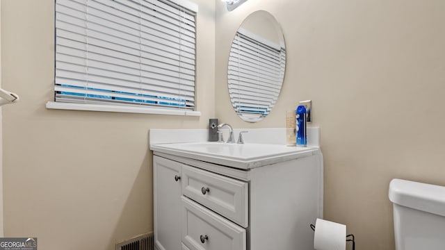 bathroom with vanity and toilet