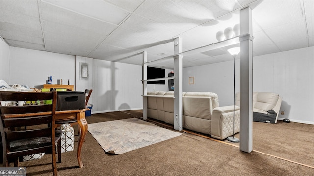 office with a paneled ceiling and dark carpet