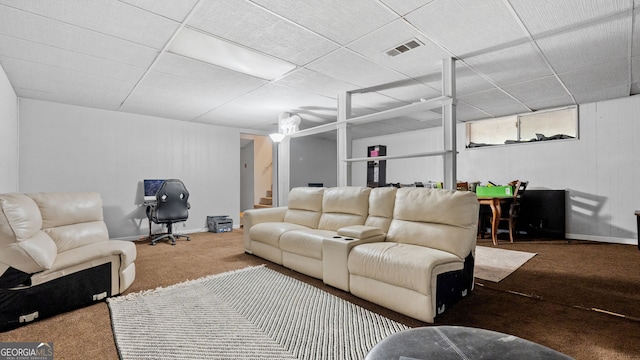 living room featuring a drop ceiling